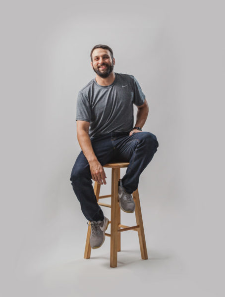 James sitting on a barstool